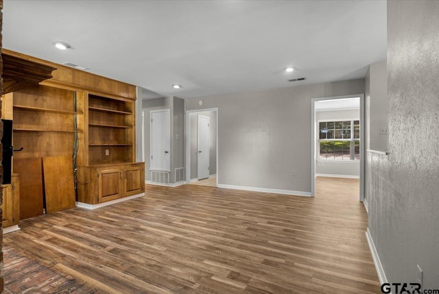 303 Westwood Dr, Troup, TX 75789 - unfurnished living room with baseboards, wood finished floors, and recessed lighting