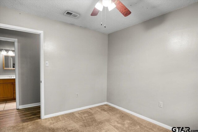 303 Westwood Dr, Troup, TX 75789 - spare room with ceiling fan, baseboards, light carpet, and a textured ceiling