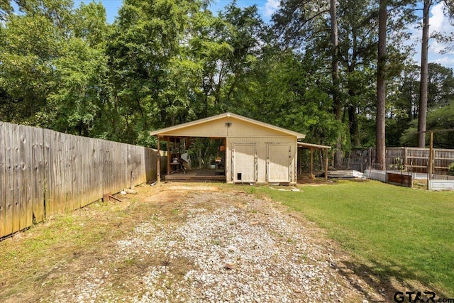 303 Westwood Dr, Troup, TX 75789 - view of shed featuring driveway, a garden, and a carport
