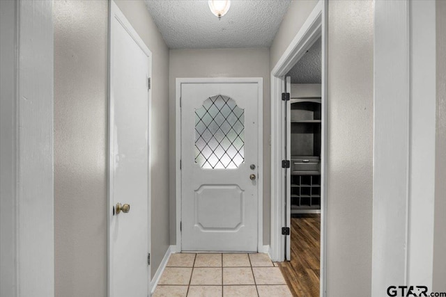 303 Westwood Dr, Troup, TX 75789 - entryway featuring a textured ceiling, light tile patterned floors, and baseboards