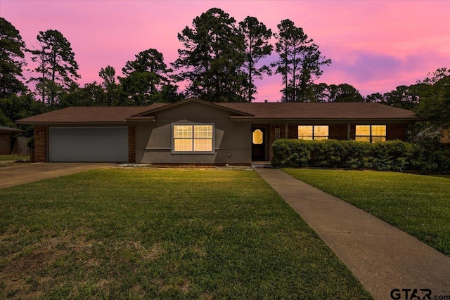 303 Westwood Dr, Troup, TX 75789 - ranch-style home featuring a garage, concrete driveway, and a lawn