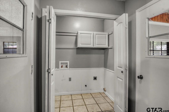 303 Westwood Dr, Troup, TX 75789 - washroom featuring electric dryer hookup, hookup for a washing machine, gas dryer hookup, light tile patterned flooring, and a wainscoted wall