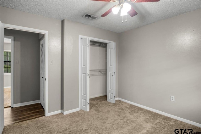 303 Westwood Dr, Troup, TX 75789 - unfurnished bedroom featuring a closet, carpet, a textured ceiling, and baseboards