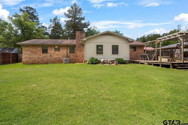 303 Westwood Dr, Troup, TX 75789 - rear view of property with a chimney, a deck, and central AC unit