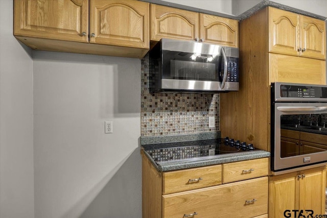 303 Westwood Dr, Troup, TX 75789 - kitchen with appliances with stainless steel finishes, decorative backsplash, and dark countertops