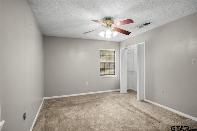 303 Westwood Dr, Troup, TX 75789 - unfurnished bedroom with carpet, a textured ceiling, baseboards, a closet, and a ceiling fan