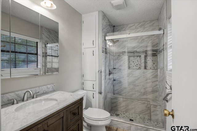 303 Westwood Dr, Troup, TX 75789 - full bath featuring toilet, a textured ceiling, vanity, and a shower stall
