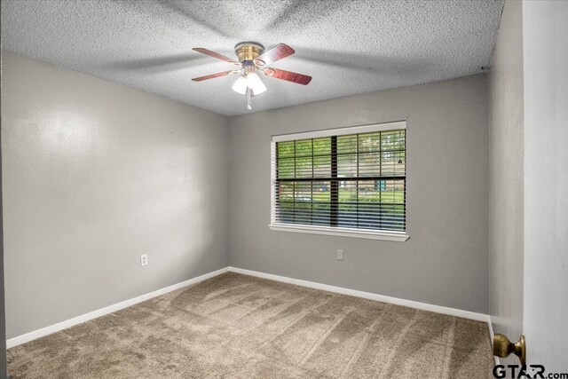 303 Westwood Dr, Troup, TX 75789 - carpeted empty room featuring a ceiling fan, baseboards, and a textured ceiling