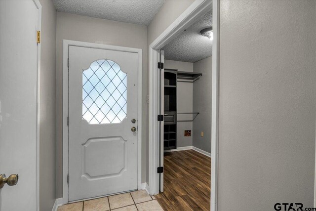 303 Westwood Dr, Troup, TX 75789 - entryway with a textured ceiling and baseboards