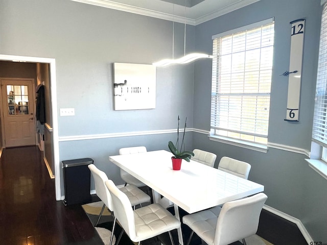 dining area with dark wood-type flooring and ornamental molding