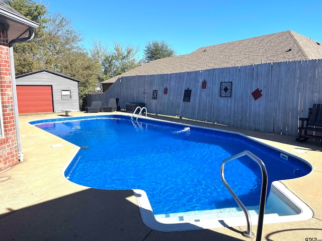 view of pool featuring an outbuilding