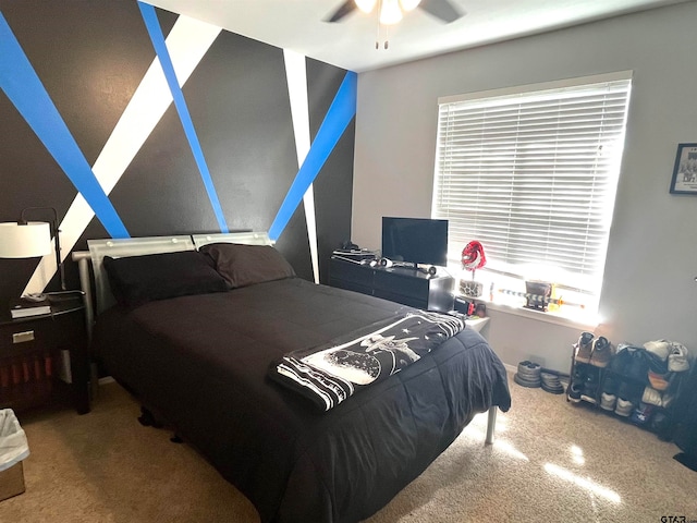 bedroom featuring ceiling fan and carpet