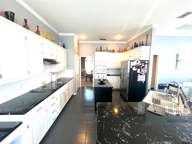 kitchen featuring stainless steel fridge, crown molding, white cabinetry, and sink