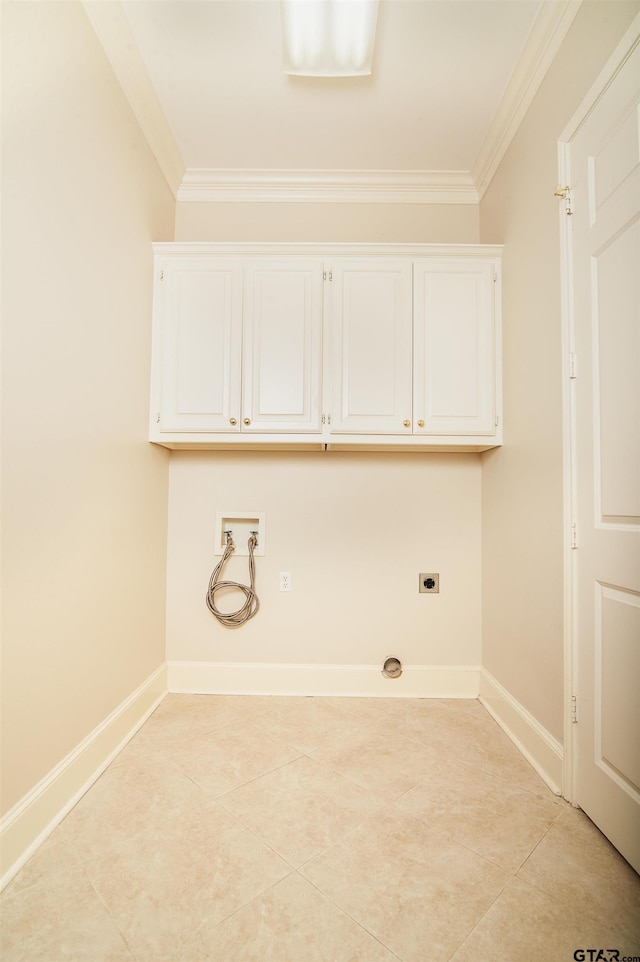 washroom featuring washer hookup, electric dryer hookup, cabinets, and ornamental molding