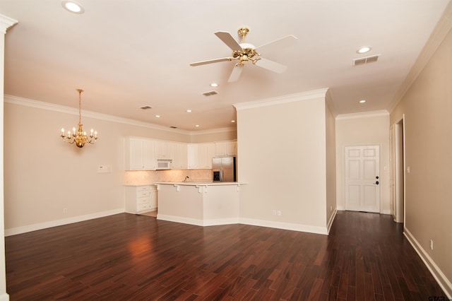 unfurnished living room with ceiling fan with notable chandelier, dark hardwood / wood-style flooring, and crown molding