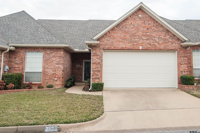 ranch-style house with a garage and a front lawn