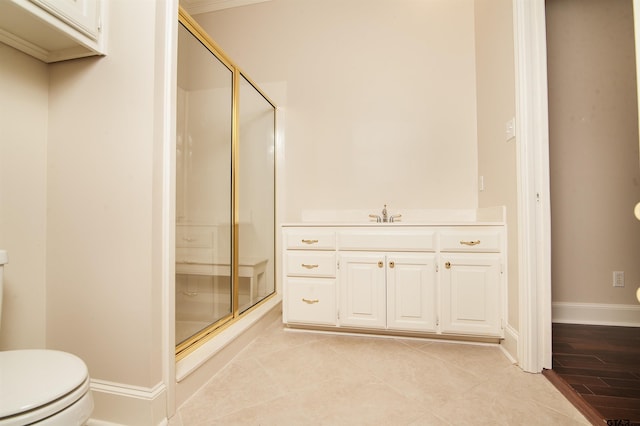 bathroom with vanity, toilet, and a shower with shower door