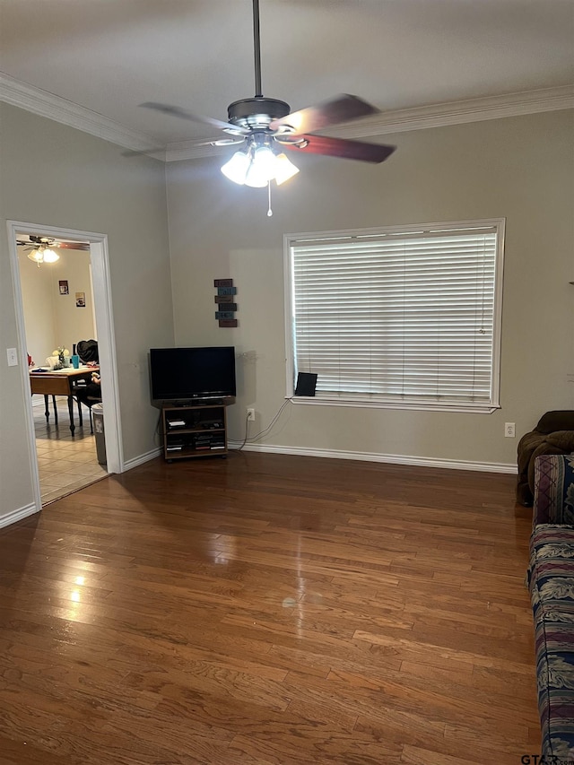 unfurnished living room with dark wood-type flooring, ceiling fan, and crown molding