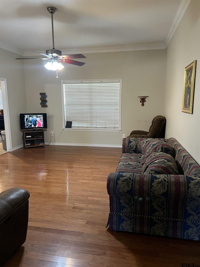 living room with hardwood / wood-style floors, crown molding, and ceiling fan