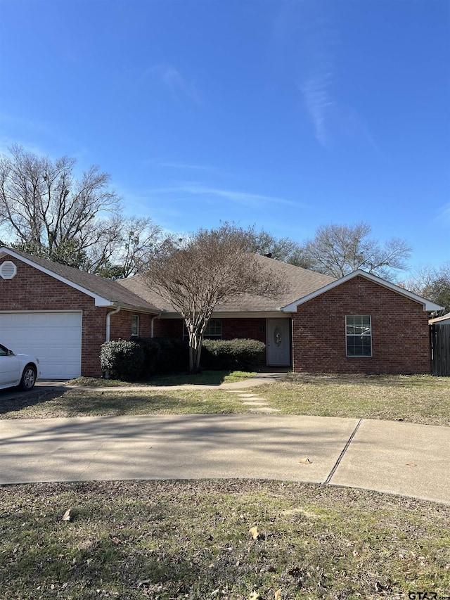 single story home featuring a garage and a front lawn