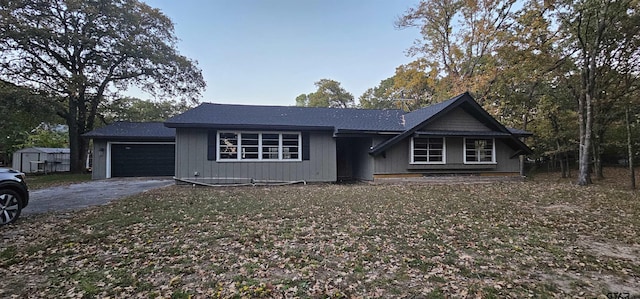 view of front of house with aphalt driveway and a garage