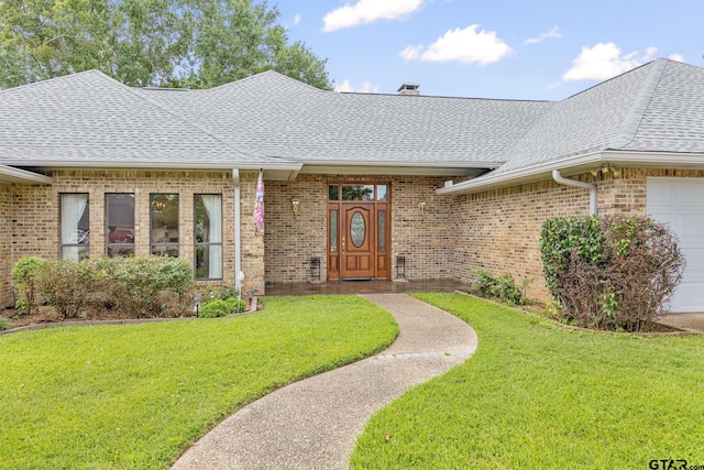 215 S Bay Dr, Bullard, TX 75757 - doorway to property featuring roof with shingles, an attached garage, a lawn, and brick siding