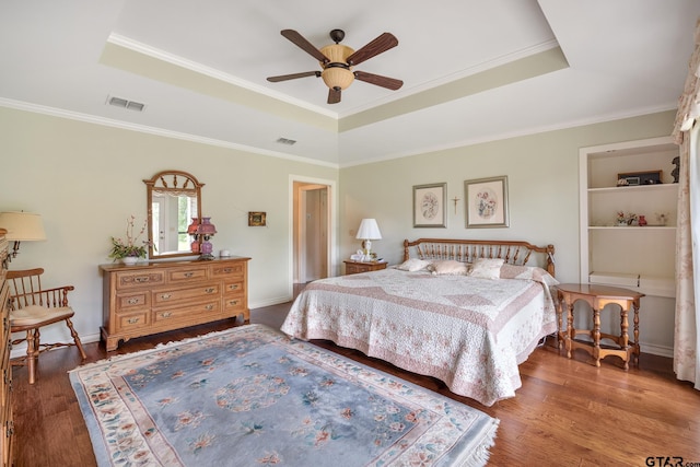 215 S Bay Dr, Bullard, TX 75757 - bedroom with a tray ceiling, wood finished floors, ornamental molding, and a ceiling fan