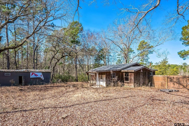 exterior space with an outdoor structure and fence