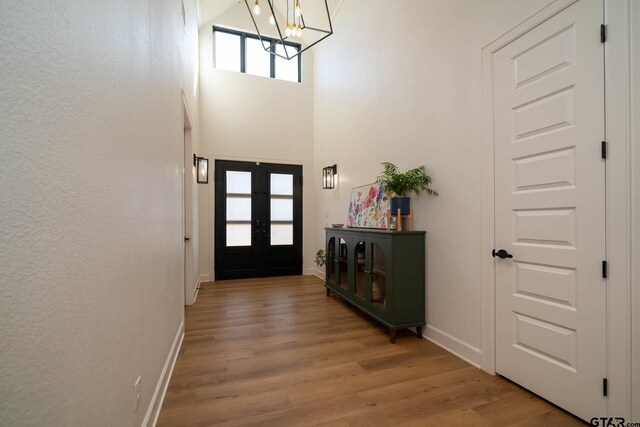 24579 Crk 4117, Frankston, TX 75763 - entrance foyer with a chandelier, light wood-style flooring, and a high ceiling