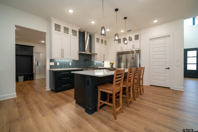 24579 Crk 4117, Frankston, TX 75763 - kitchen featuring wall chimney exhaust hood, appliances with stainless steel finishes, light wood-style floors, and recessed lighting