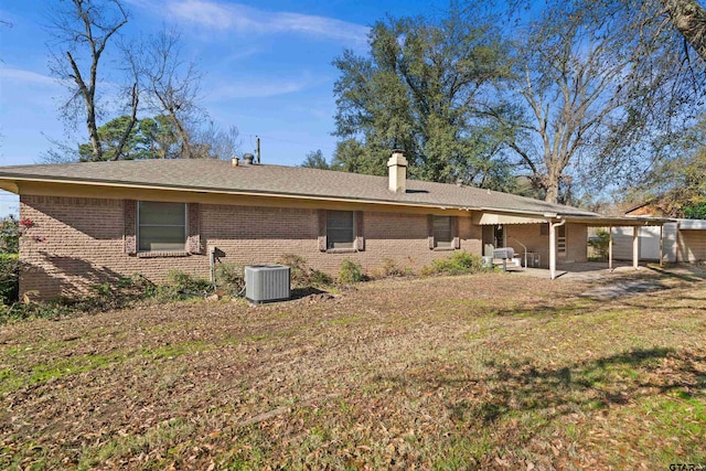 rear view of property featuring a patio and cooling unit