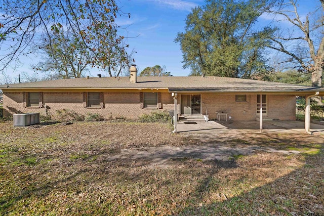 rear view of house with central AC unit and a patio area