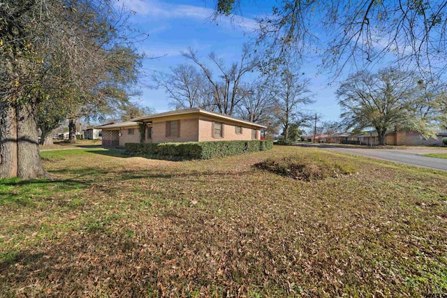 view of side of property with a yard