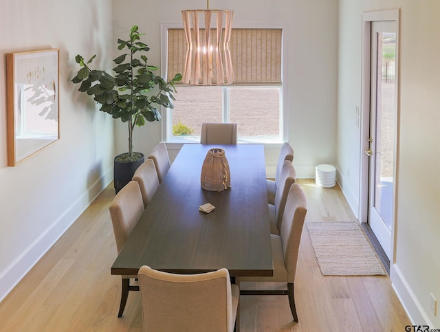 dining room featuring light wood-style flooring and baseboards