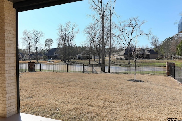 view of yard featuring a residential view and fence