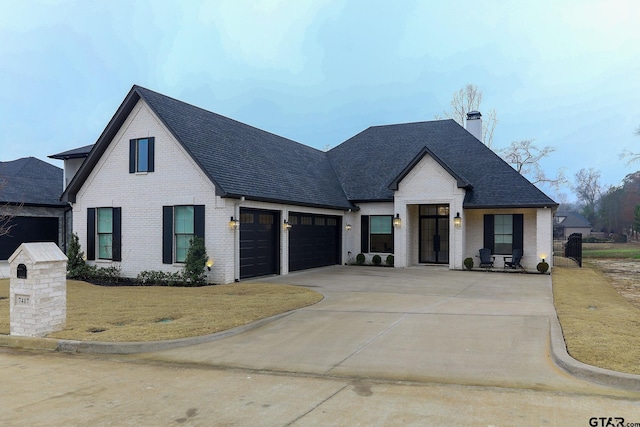 view of front of home featuring a garage and a front yard