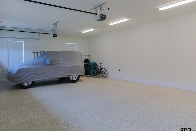 garage featuring baseboards and a garage door opener