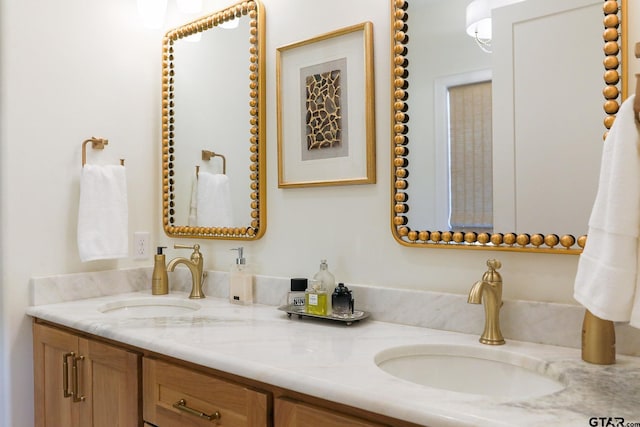 full bathroom featuring double vanity and a sink