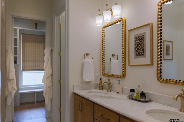 full bathroom with double vanity and a sink