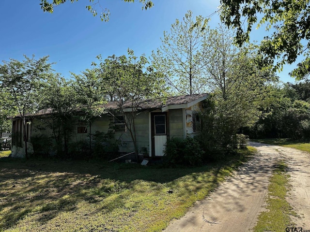 view of side of property with a yard