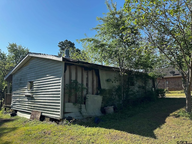 view of side of home featuring a yard