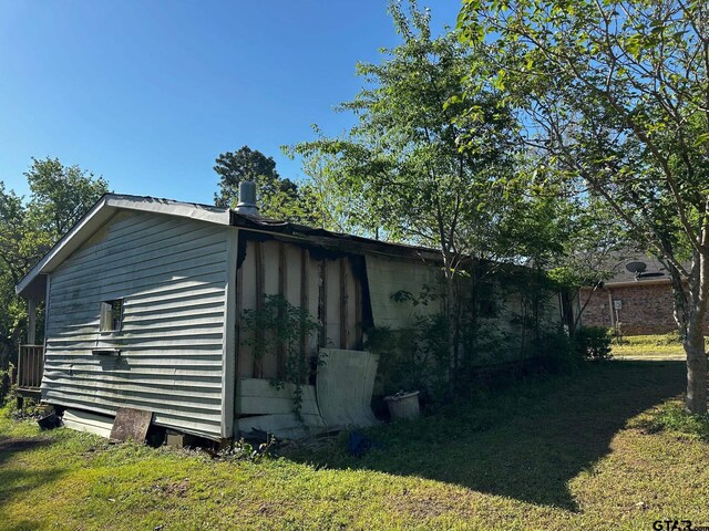 view of side of home featuring a yard