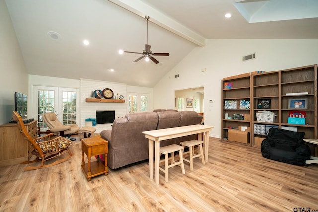431 Gifford St, Rusk, TX 75785 - living area featuring high vaulted ceiling, light wood-style flooring, a ceiling fan, beam ceiling, and a brick fireplace