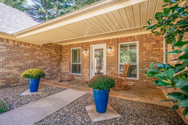 431 Gifford St, Rusk, TX 75785 - view of exterior entry featuring brick siding and roof with shingles