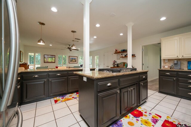 431 Gifford St, Rusk, TX 75785 - kitchen with stainless steel appliances, light tile patterned flooring, decorative columns, ceiling fan, and light stone countertops