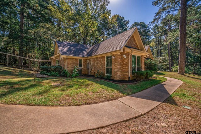 431 Gifford St, Rusk, TX 75785 - view of property exterior featuring brick siding, a yard, and roof with shingles