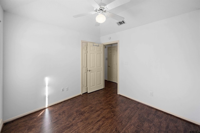 unfurnished room with visible vents, ceiling fan, baseboards, and wood finished floors