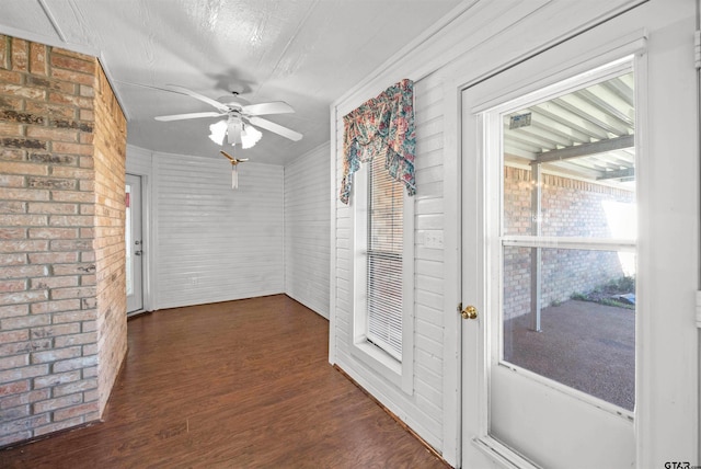 unfurnished sunroom featuring a ceiling fan