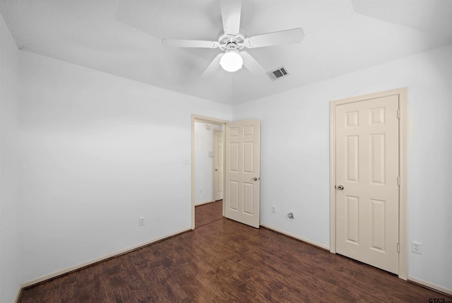 unfurnished room featuring ceiling fan, wood finished floors, visible vents, and baseboards