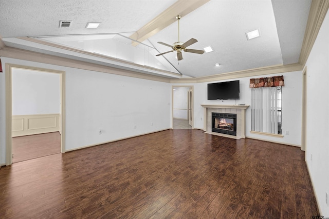 unfurnished living room featuring visible vents, lofted ceiling with beams, ceiling fan, wood finished floors, and a fireplace